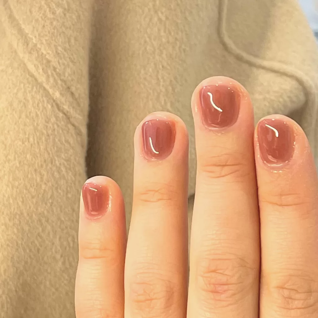 Minimalist Korean gel nails in nude pink shade, glossy finish on short natural nails