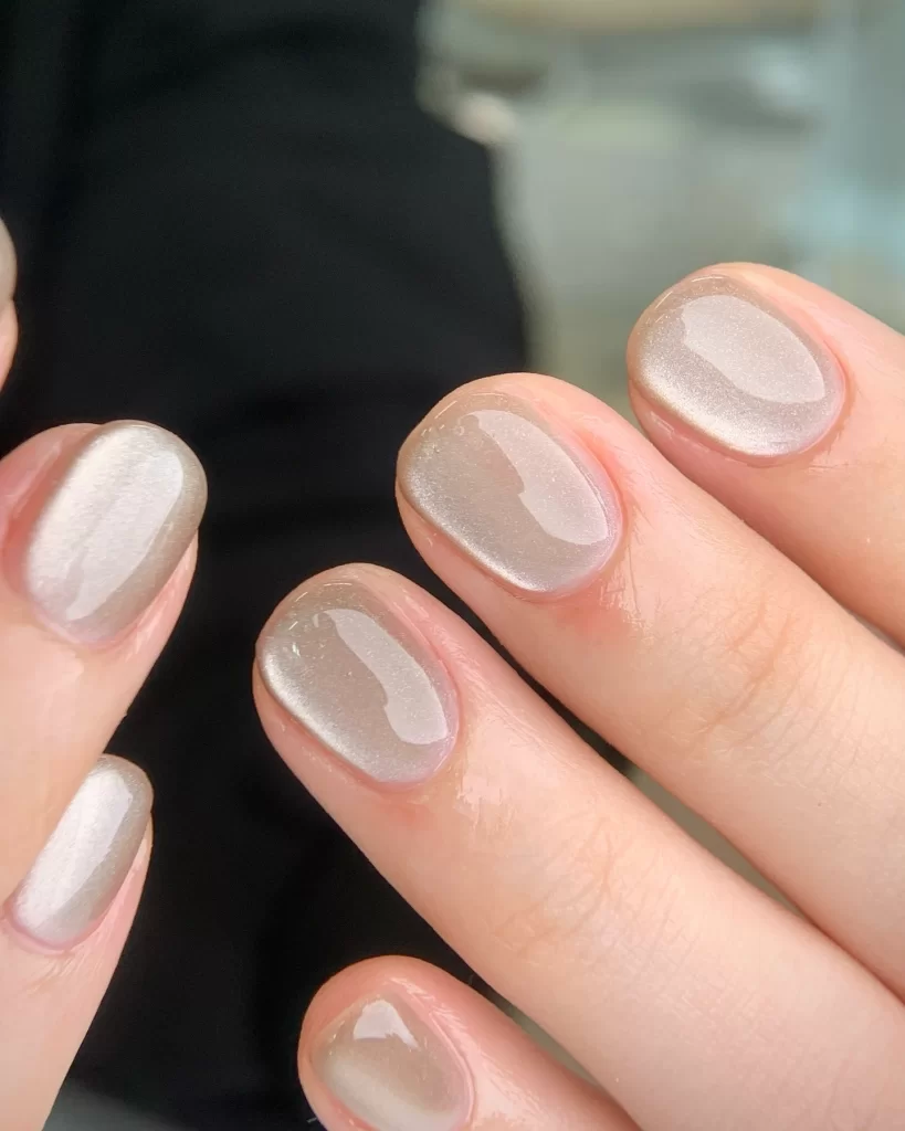 Pearl finish Korean gel nails in neutral champagne color with glossy shine