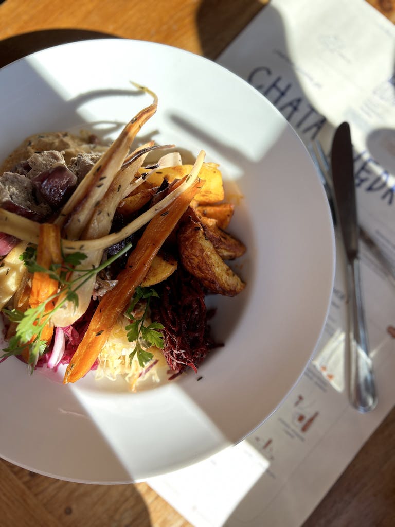 Delicious gourmet vegetable medley served in a restaurant setting, beautifully arranged on a plate.