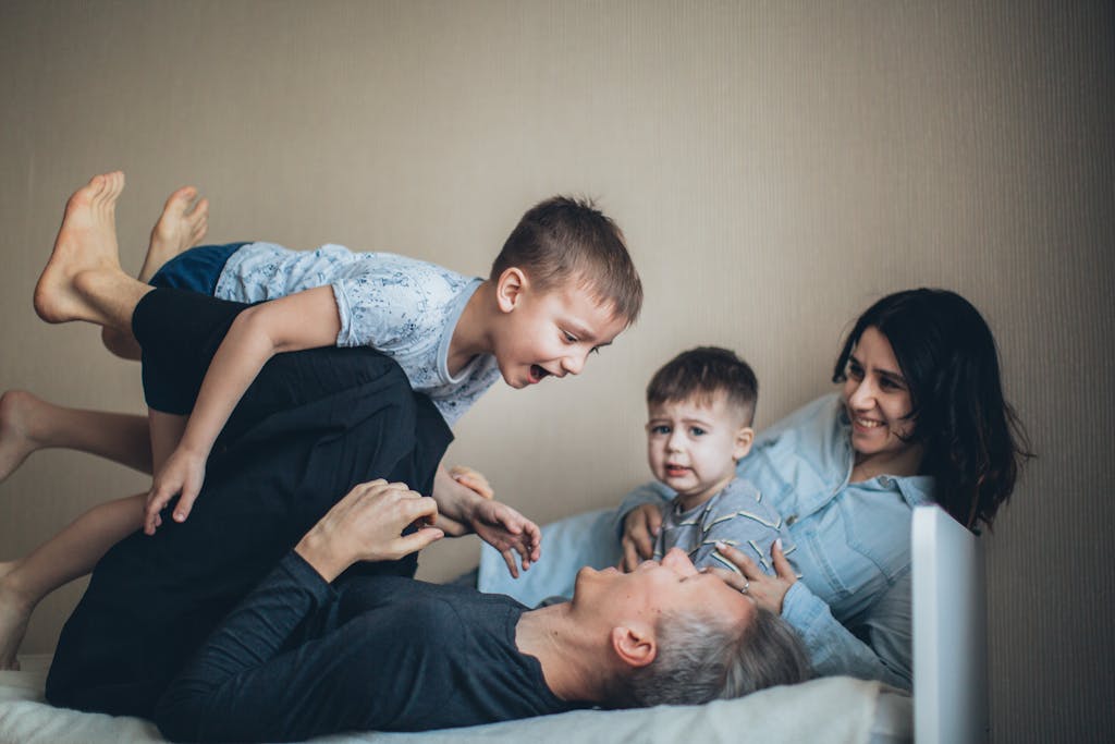 Joyful family bonding time indoors with parents and children having fun together.