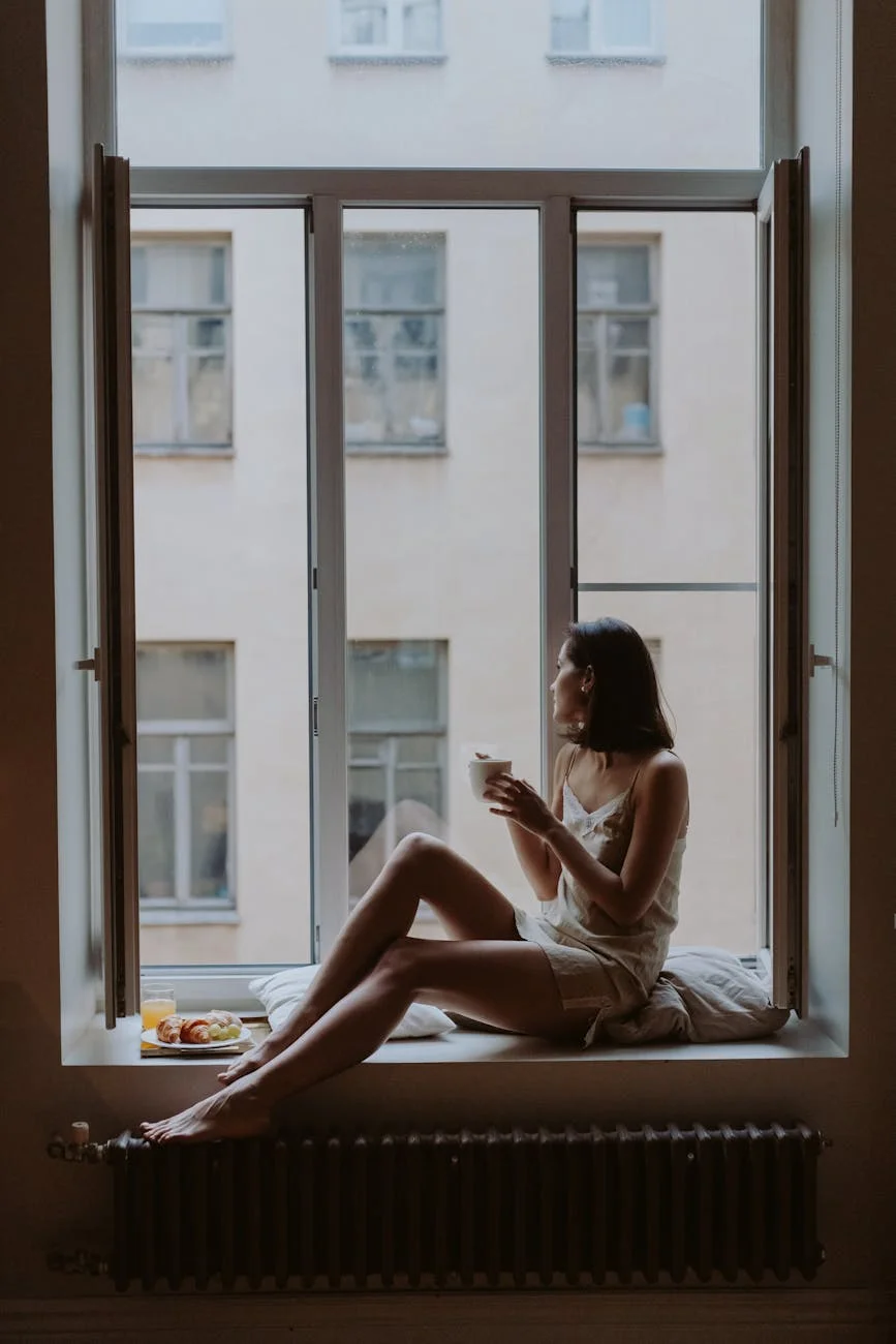 a woman having breakfast by the window