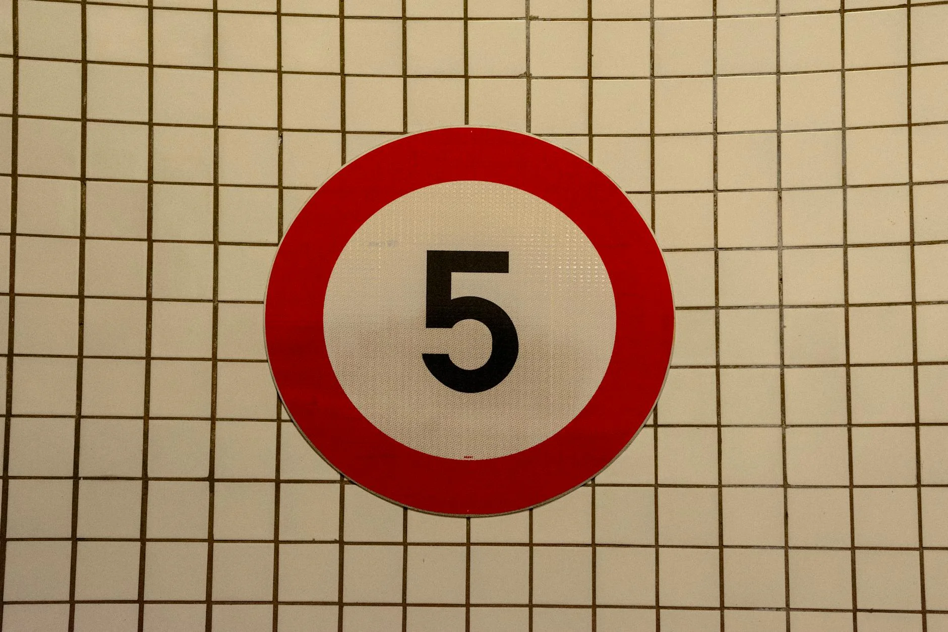 speed limit road sign on a tiled wall