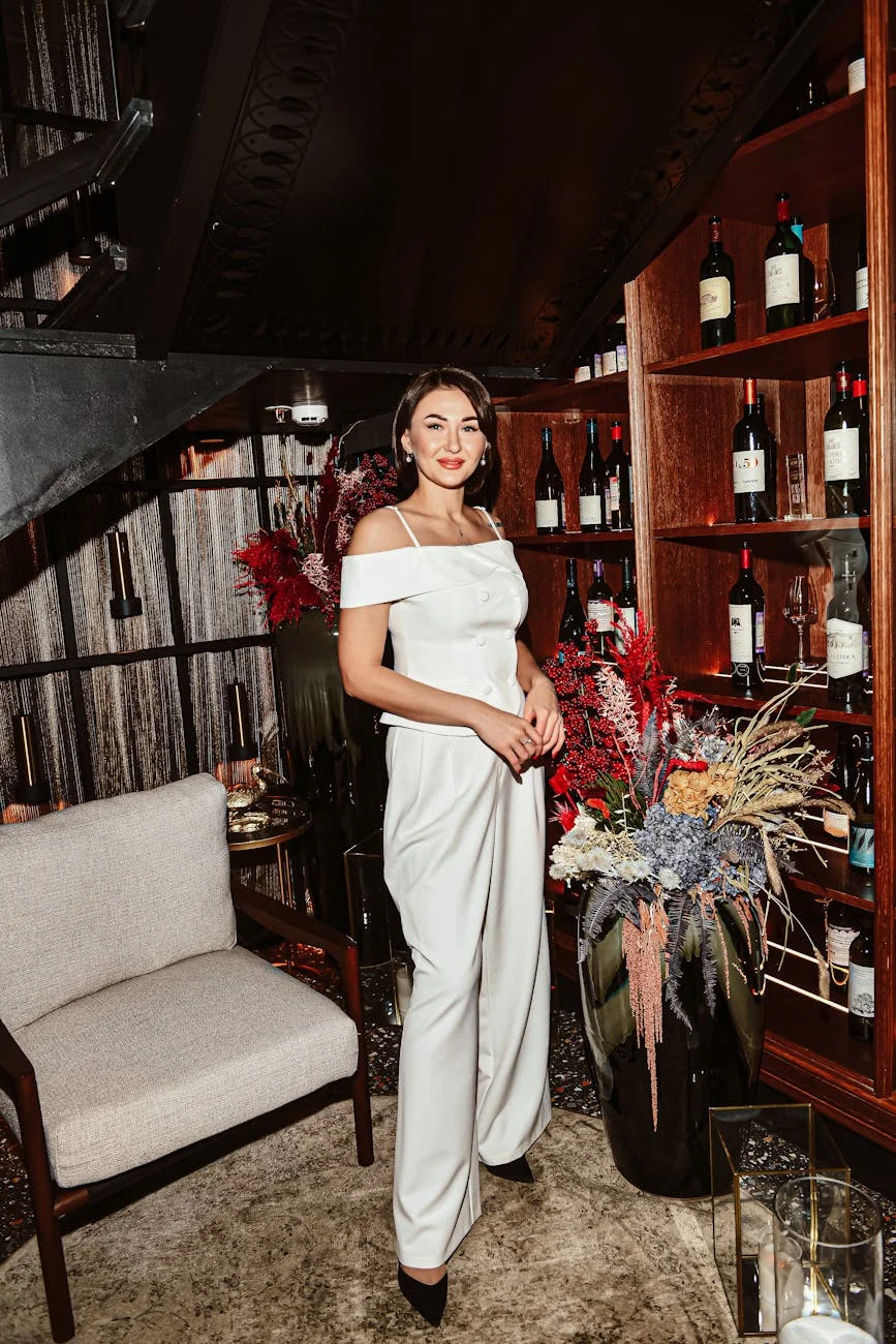 elegant woman in white dress in cozy wine room