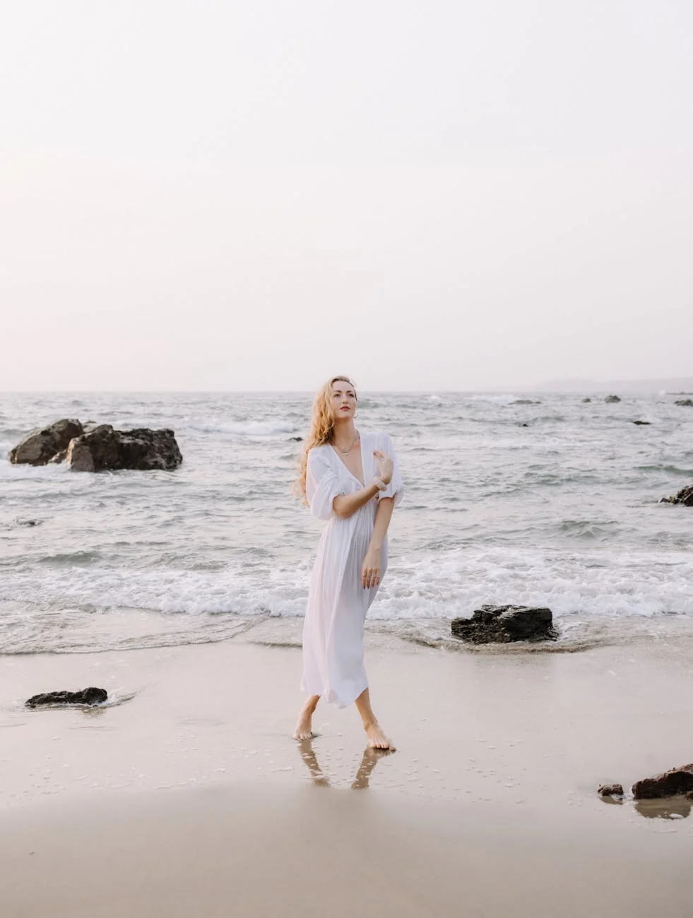 elegant woman strolling on a serene beach