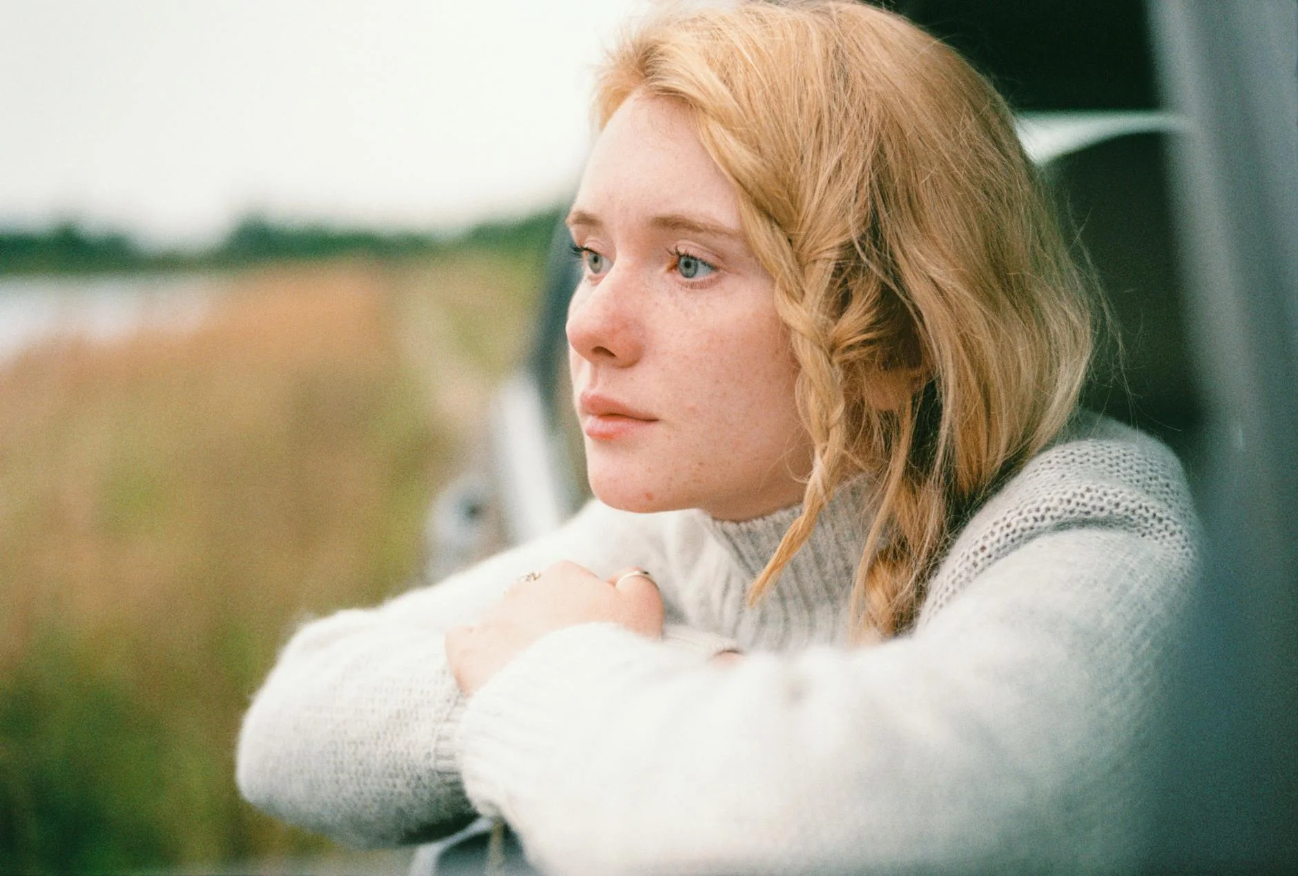 woman in white sweater thinking