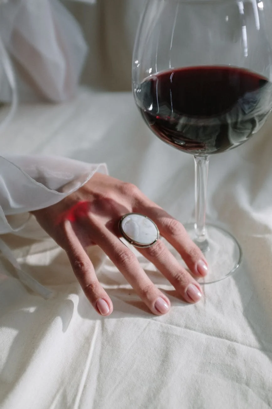 person holding clear wine glass