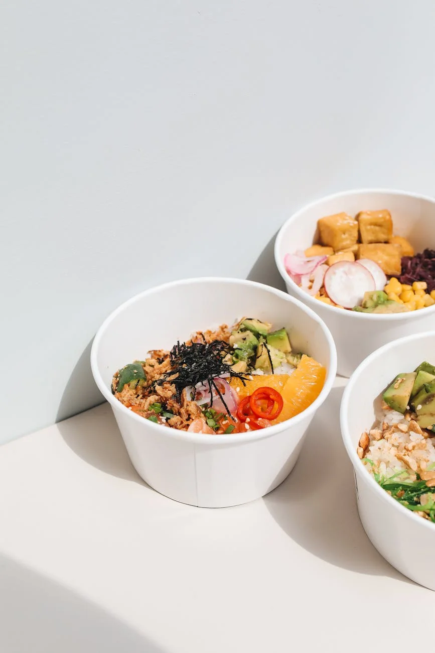delicious poke in white paper bowls