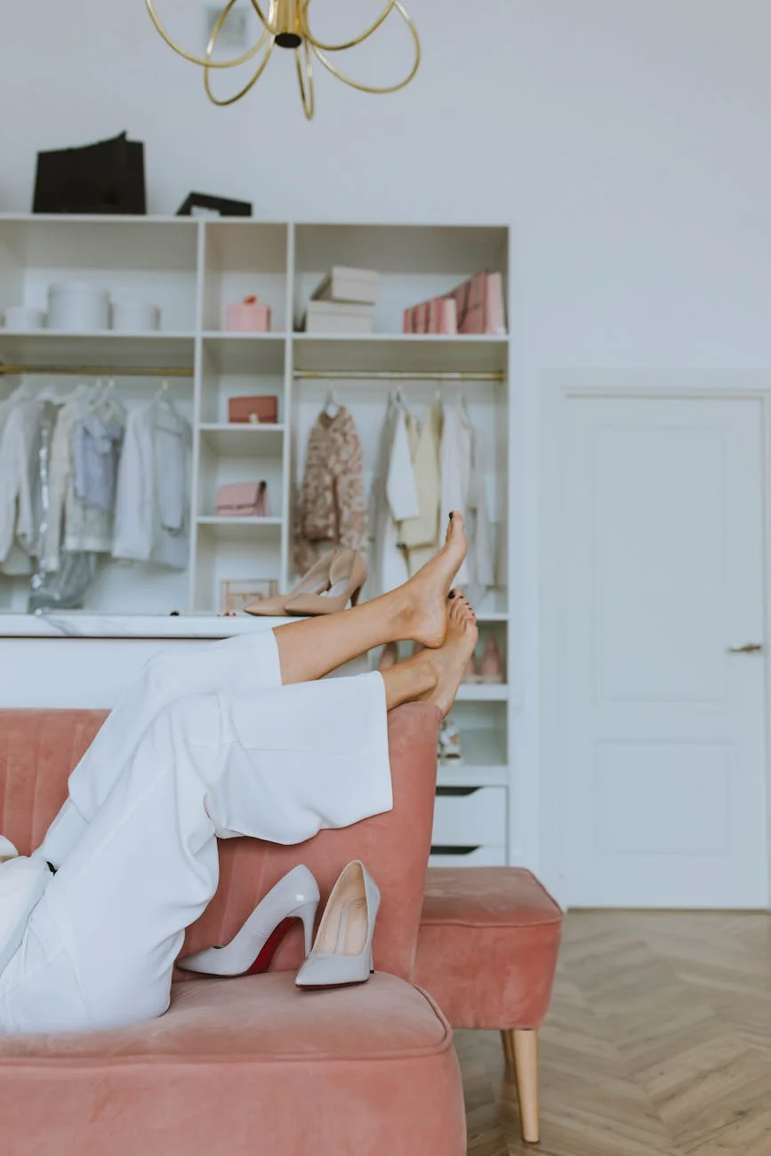 woman in white pants lying on pink sofa with barefoot up