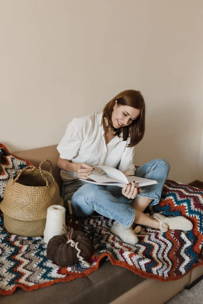 pretty woman sitting on a crochet blanket