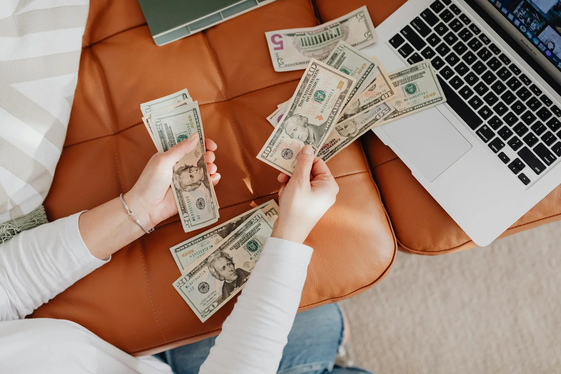 close up of woman counting dollar bills