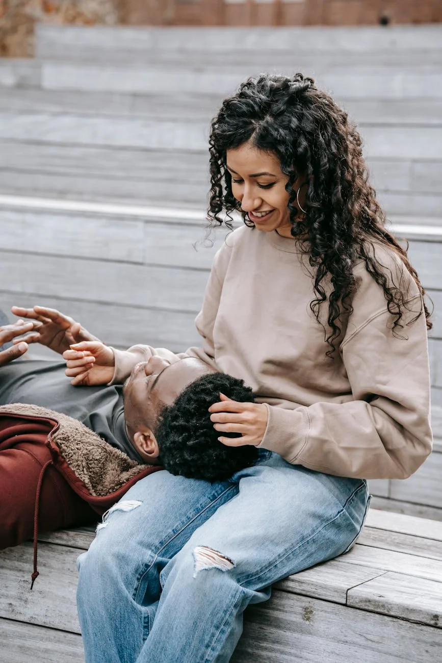 content multiracial couple talking on stairs outdoors