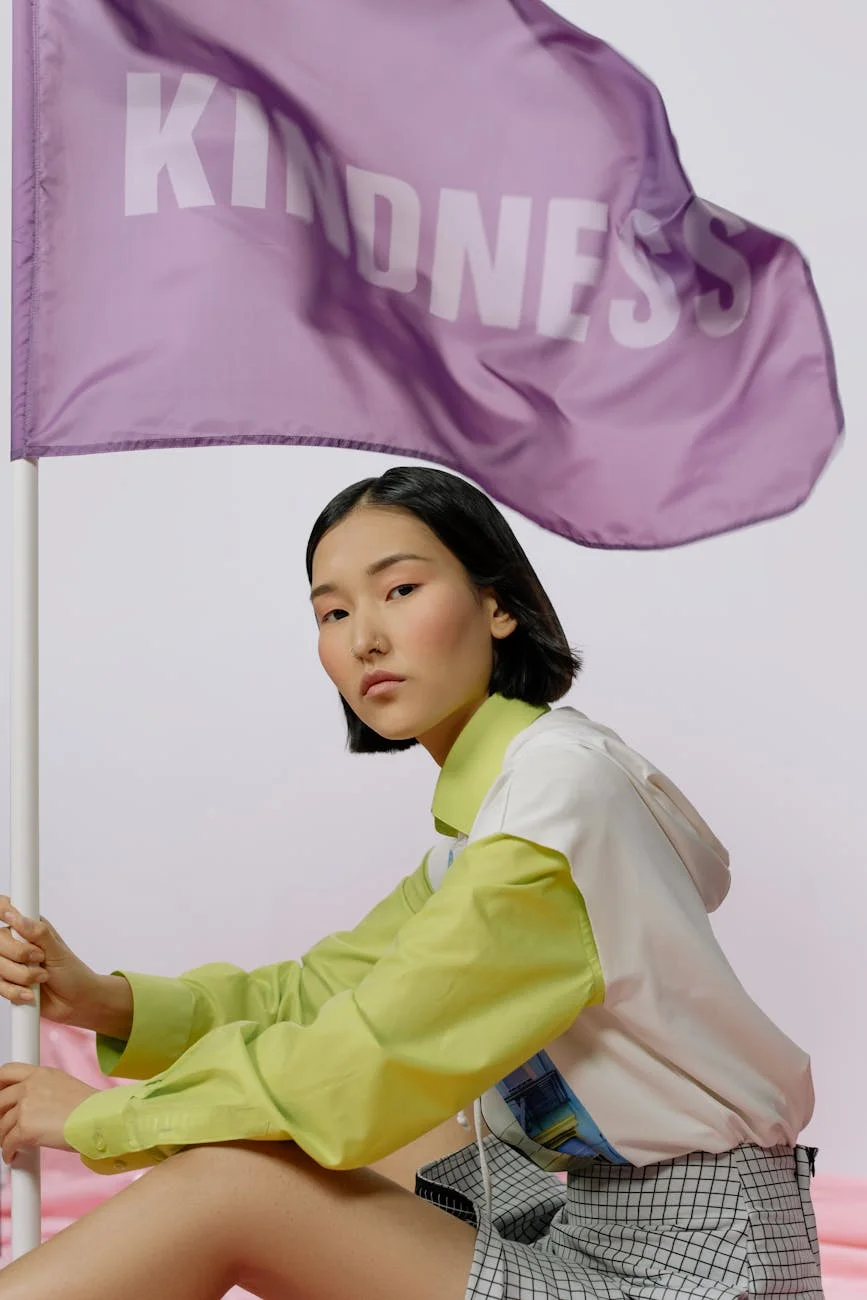a woman holding a purple kindness flag