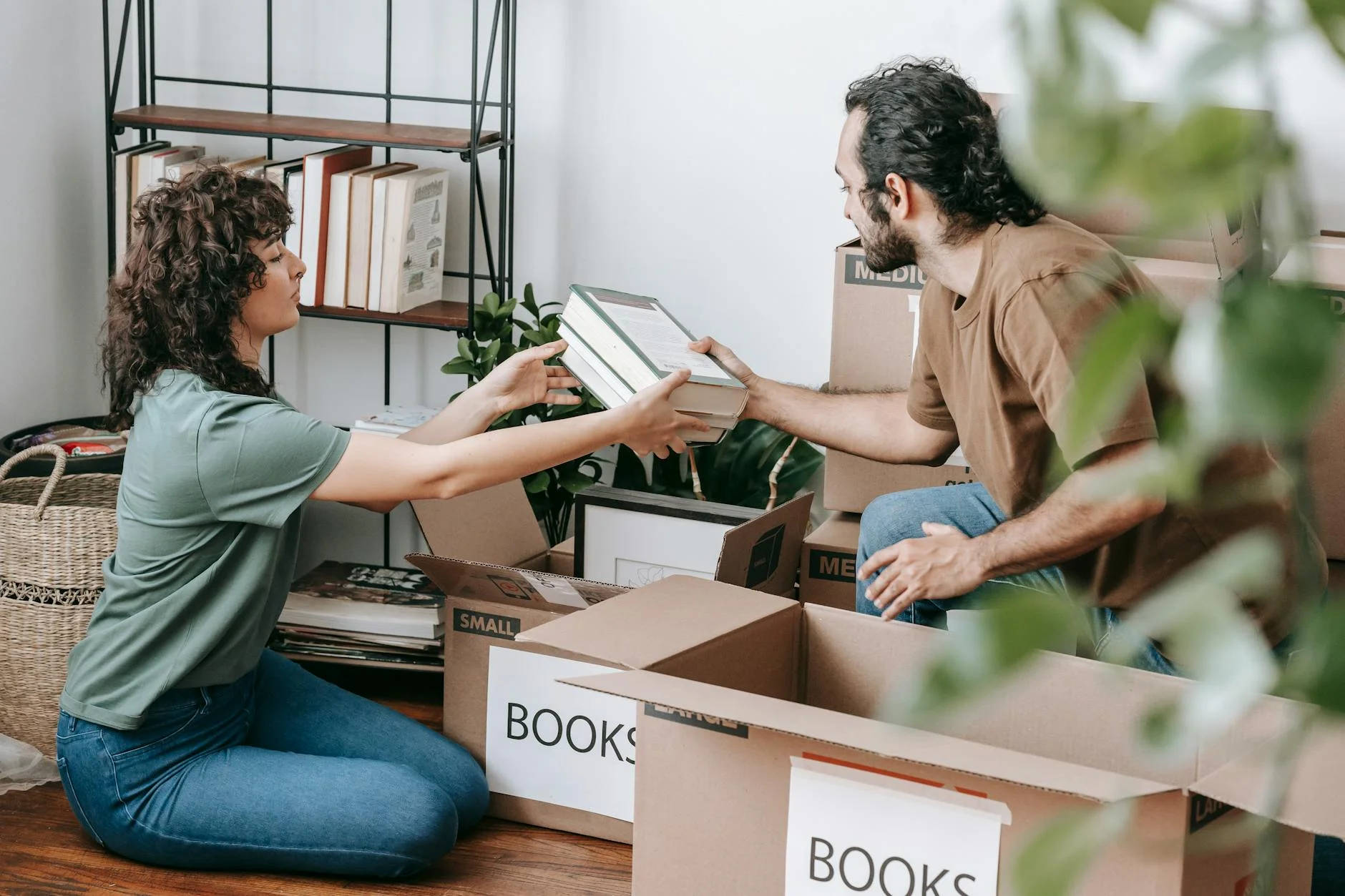 couple packing books in a box