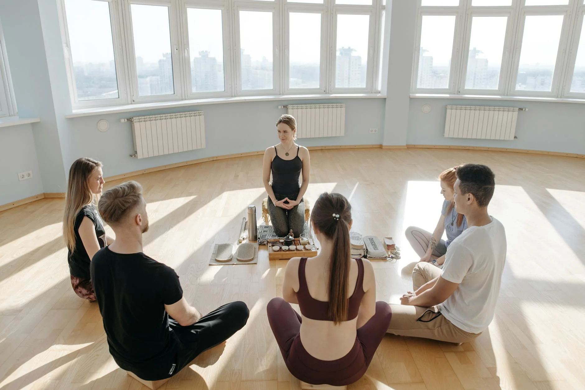 group of people in a room meditating