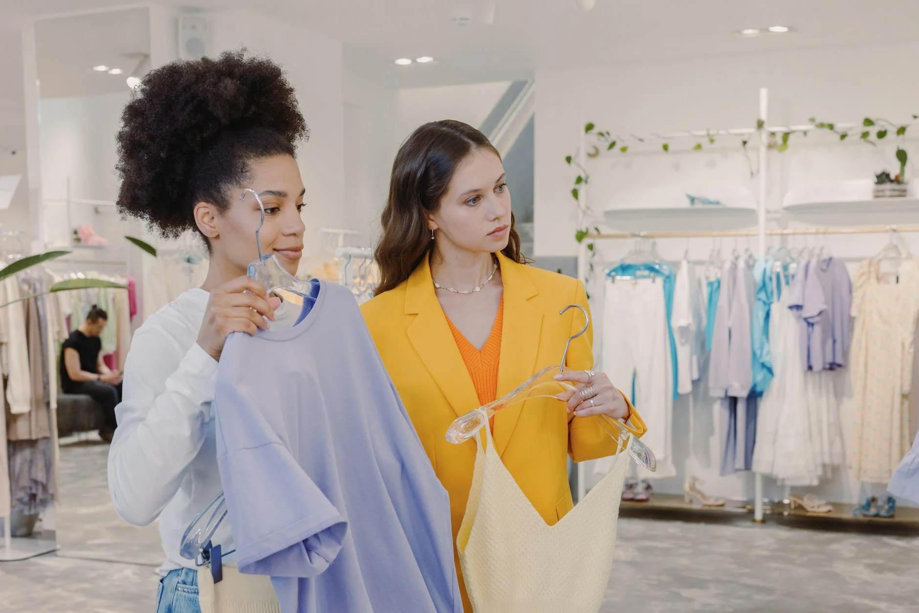 a woman looking at clothes with a personal stylist