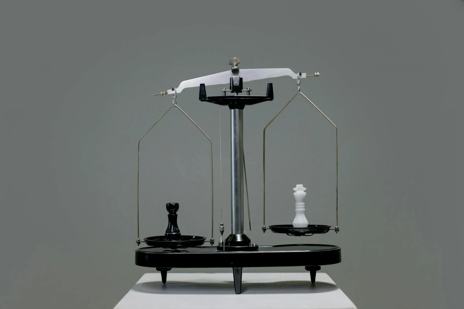 chess pieces on a scale