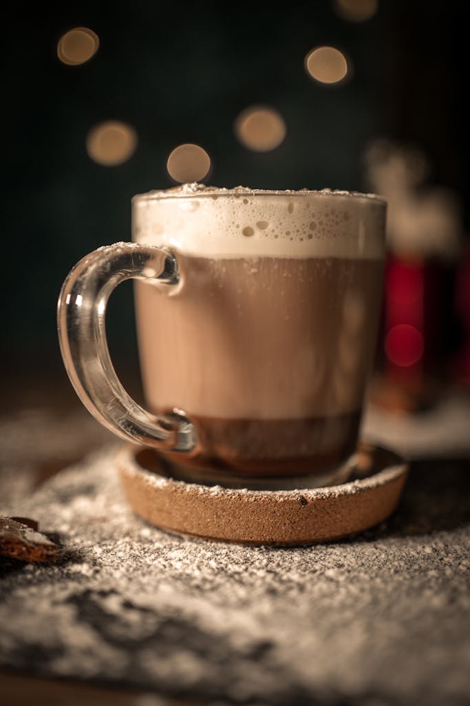 A warm mug of hot chocolate with foam, set on a rustic table, capturing a cozy winter atmosphere with bokeh lights.
