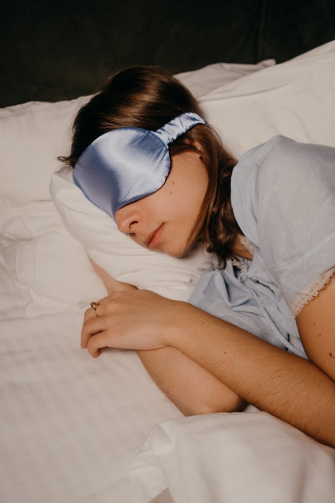 A woman peacefully sleeping with a satin eye mask, providing a sense of relaxation and comfort.