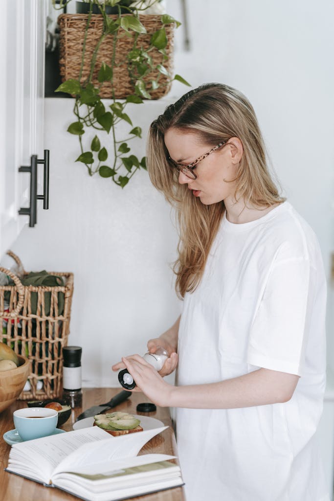 A young woman enjoys a calm morning making a healthy meal in her kitchen.