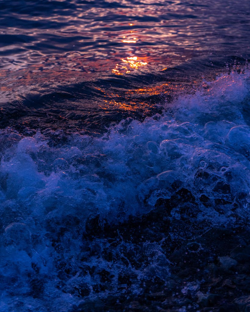 Captivating sunset over the waves of Kamchatka, Russia, with rich colors and foaming water.