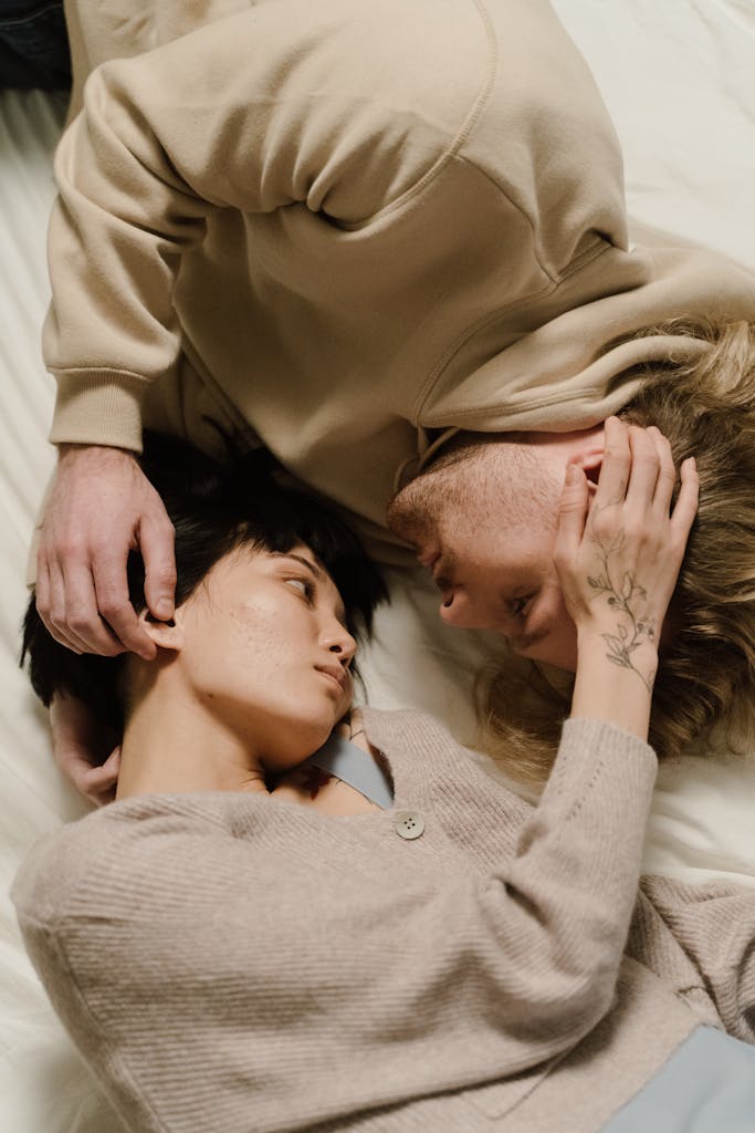 Close-up of an intimate couple lying together, expressing love and tenderness.