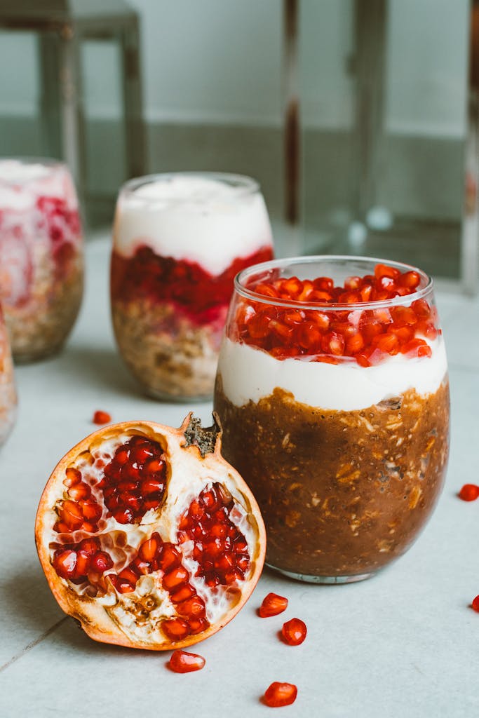 Creamy pomegranate parfait with oats, yogurt, and fresh pomegranate seeds.