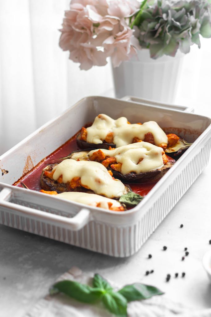 Delicious baked eggplant with melted cheese and fresh herbs.