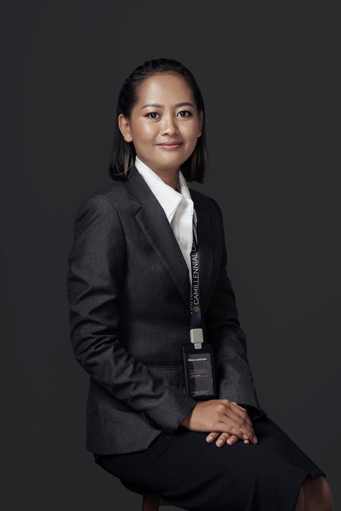 Elegant portrait of a smiling Asian woman in formal business attire, perfect for corporate branding.
