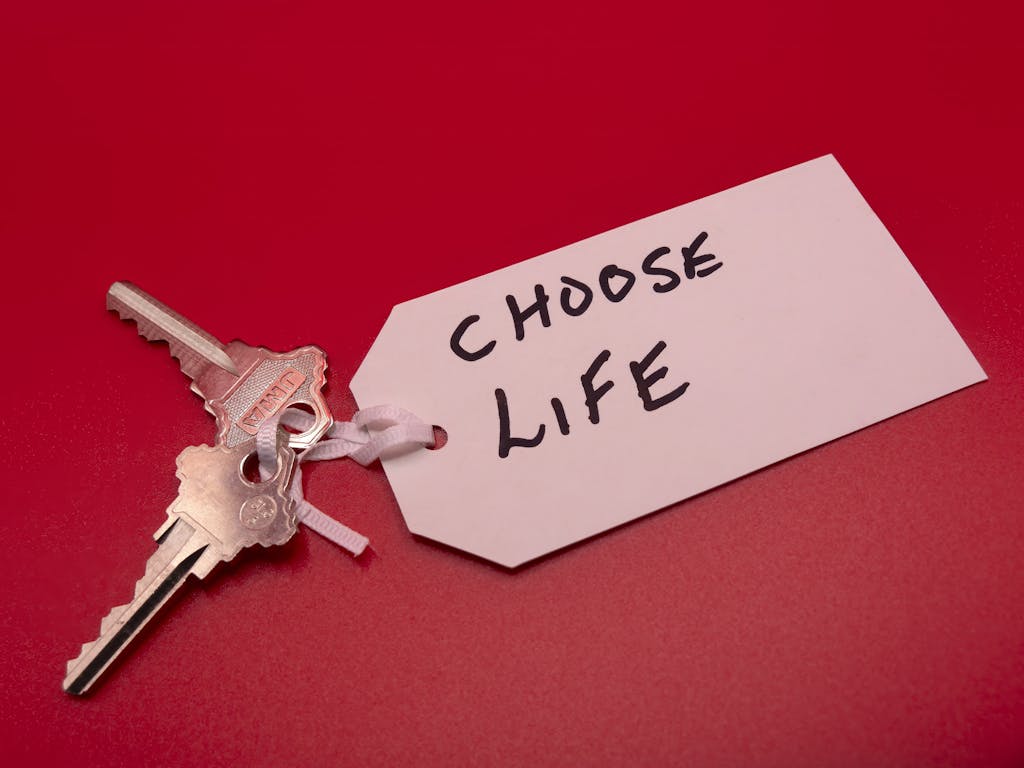 Keys on a red background with a 'Choose Life' tag, symbolizing decision-making.