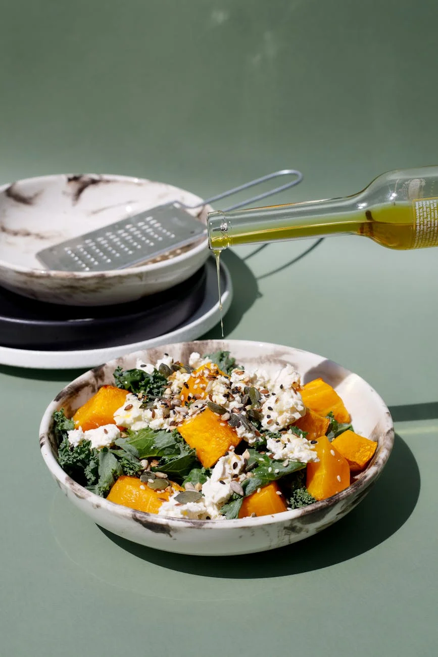 drop of olive oil added to salad made of diced pumpkin lettuce and cottage cheese