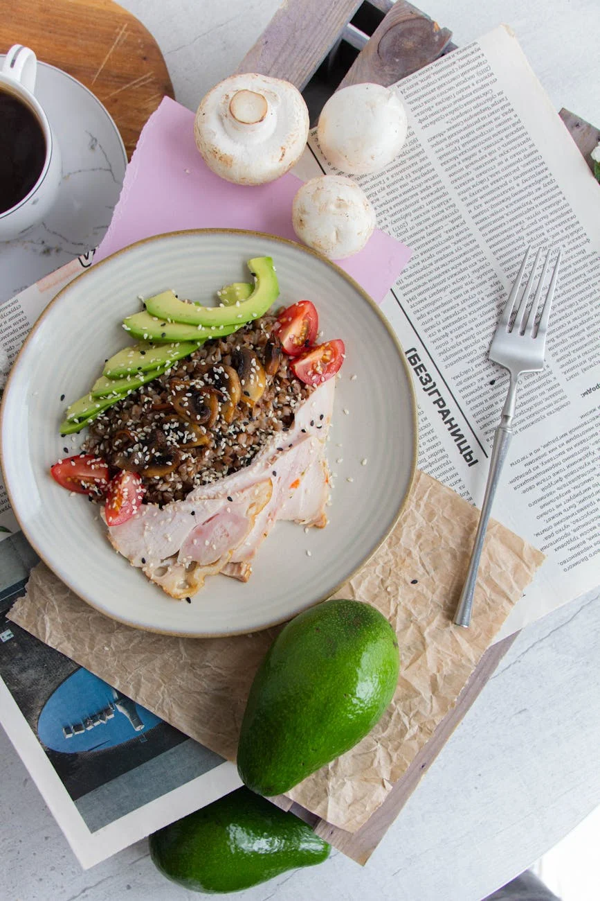 top view of a meat dish with raw vegratables and mushrooms on a newspaper