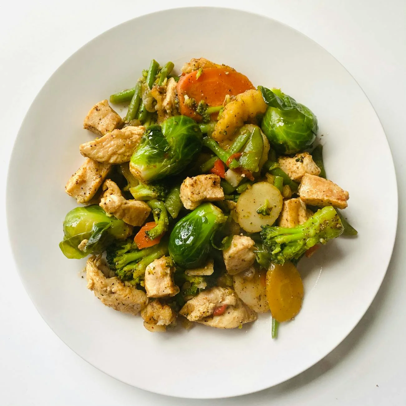 top view of delicious food with broccoli in a white plate