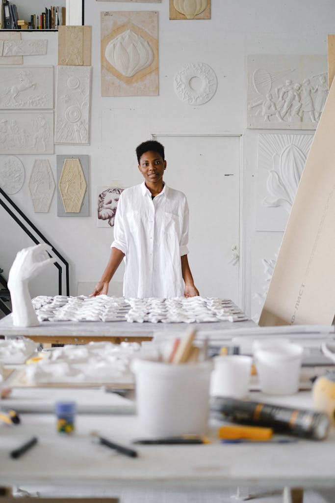 Portrait of an artist working with ceramics in a bright studio space.