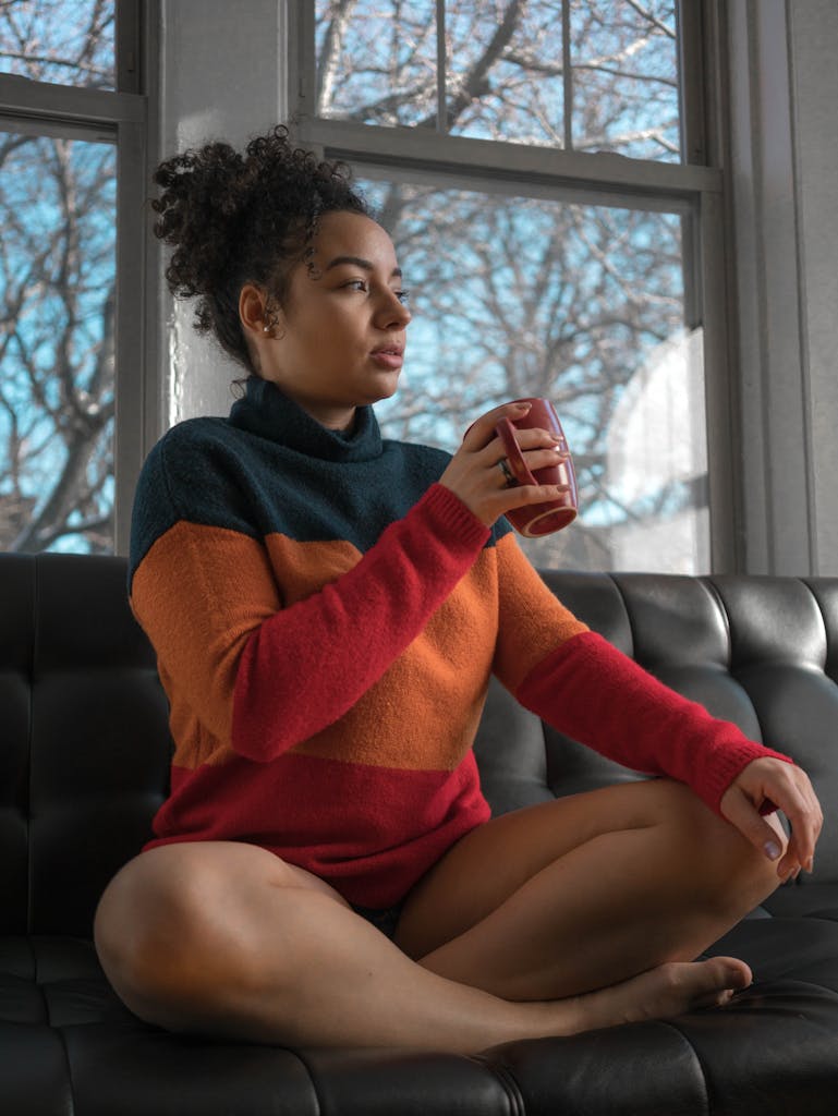 Relaxing moment indoors with a warm cup of coffee, enjoying the serene atmosphere.