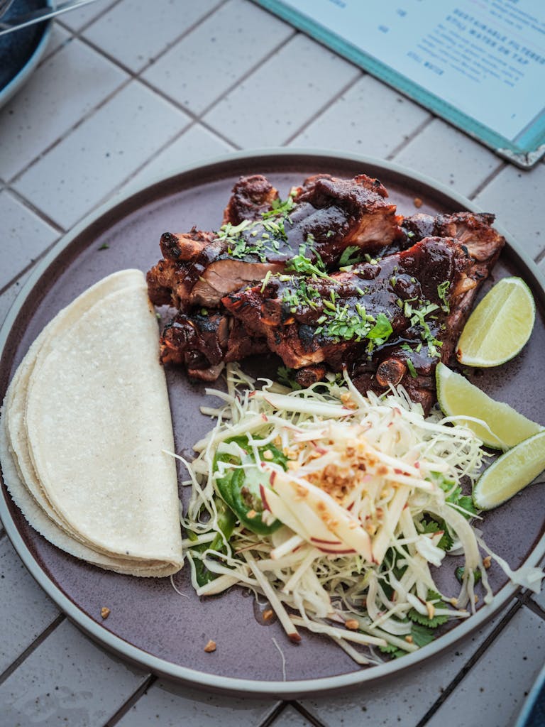 Savor a flavorful Mexican dish with tacos, meat, and fresh salad.