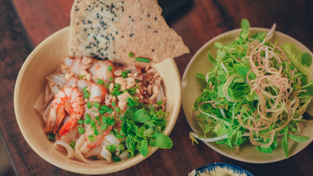Tasty shrimp noodle bowl with herbs and greens, perfect for a healthy meal.
