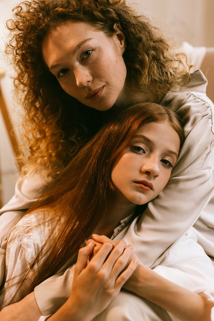 Tender portrait of a mother and daughter embracing with love and warmth.