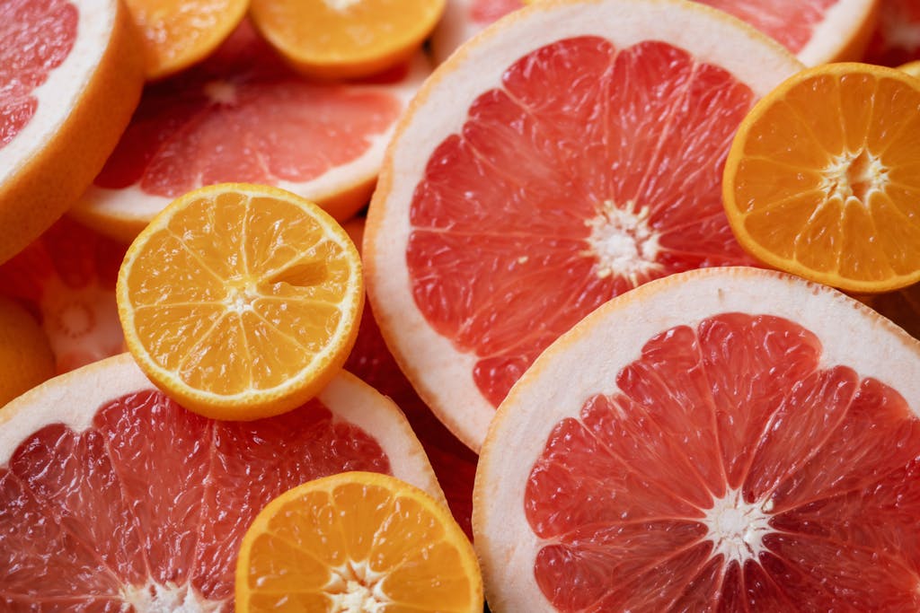 Vibrant and fresh sliced citrus fruits including oranges and grapefruits in a flat lay composition.