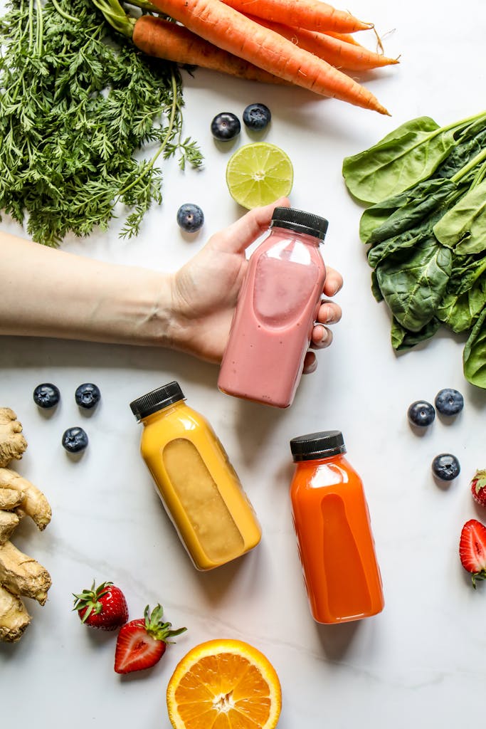Vibrant smoothies surrounded by fresh fruits and vegetables, perfect for a healthy lifestyle.