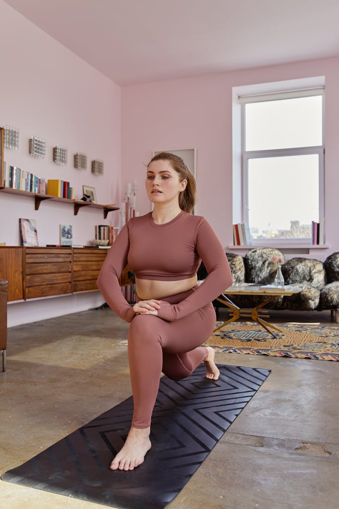 Woman practicing yoga in cozy home space with natural light