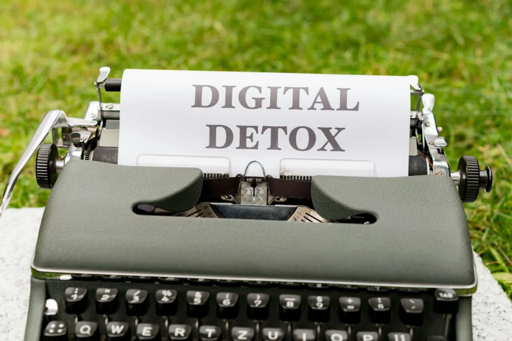 a typewriter with a paper that reads digital detox