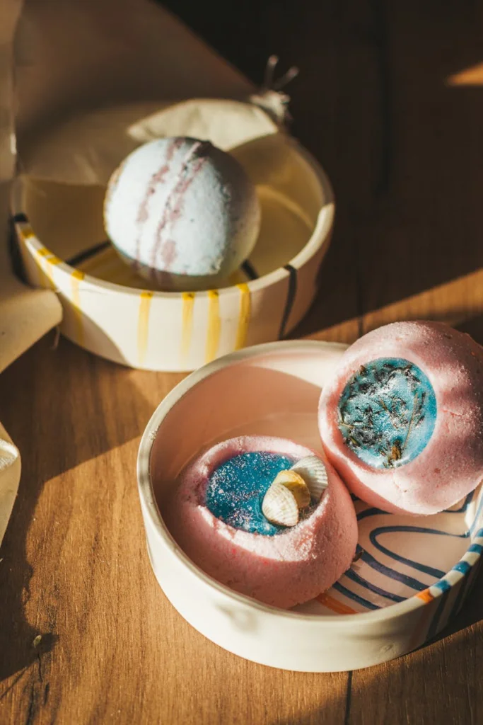 High angle fragrant acid based bath bombs stuffed with bath salt and placed in ceramic bowls in sunlight