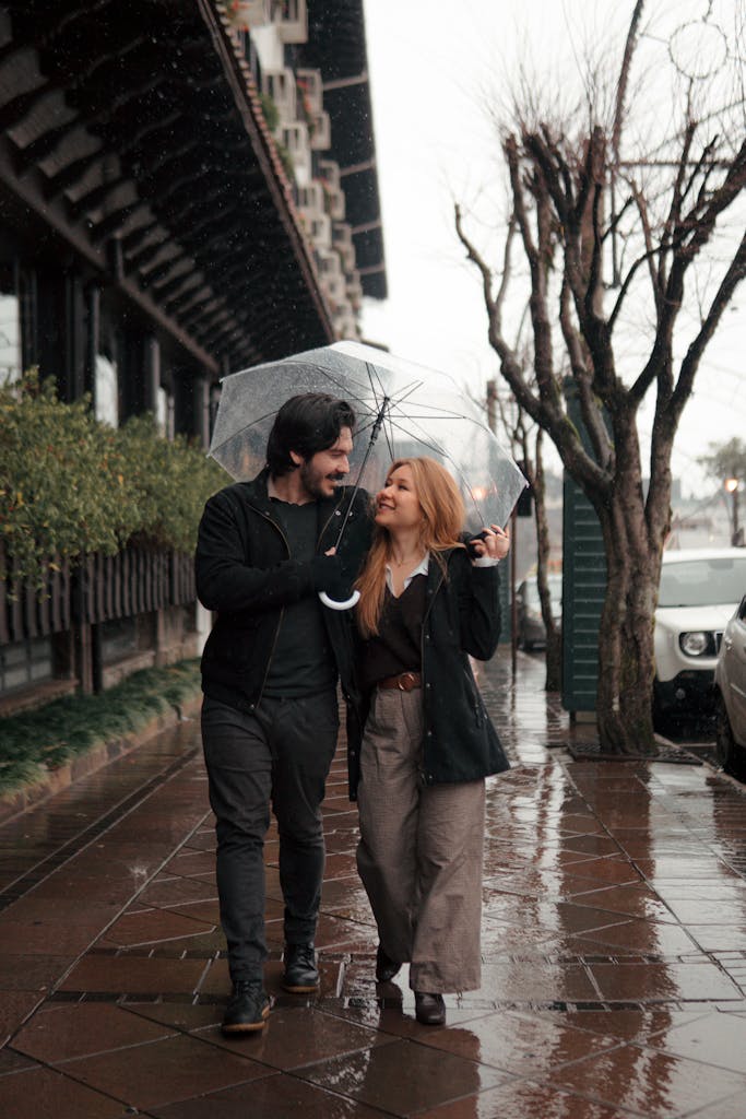 A couple shares an umbrella during a rainy day walk in Gramado, Brazil.