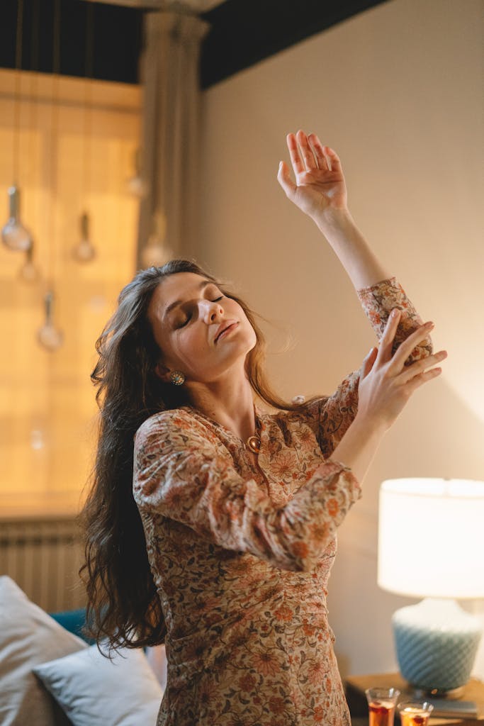 A serene portrait of a woman dancing indoors, capturing a moment of peaceful freedom.