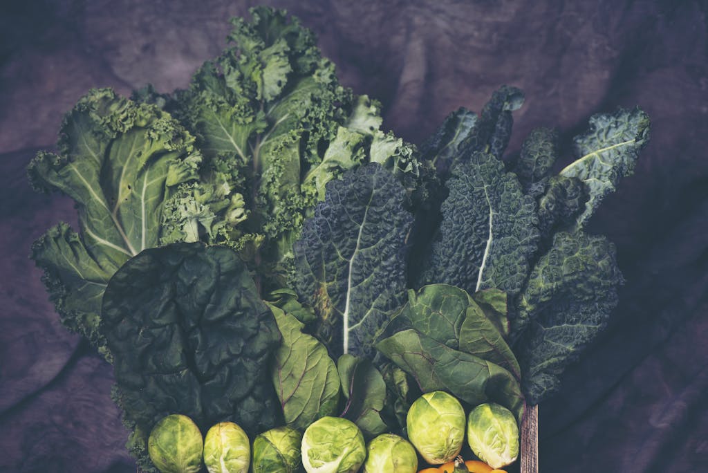 A vibrant assortment of fresh kale and Brussels sprouts showcasing healthy greens.