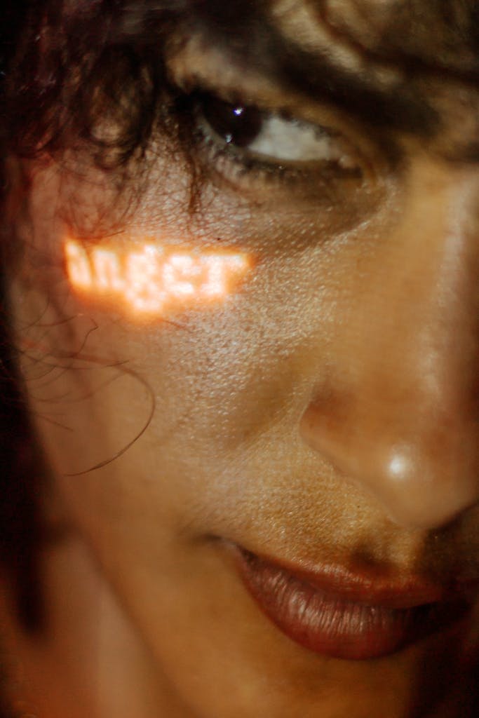 Close-up of a woman's face with 'anger' text projection in Käbschütztal, Germany.