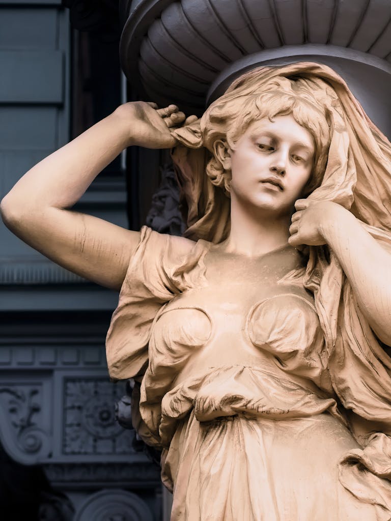 Close-up view of an intricate stone sculpture depicting a woman in a Vienna museum.