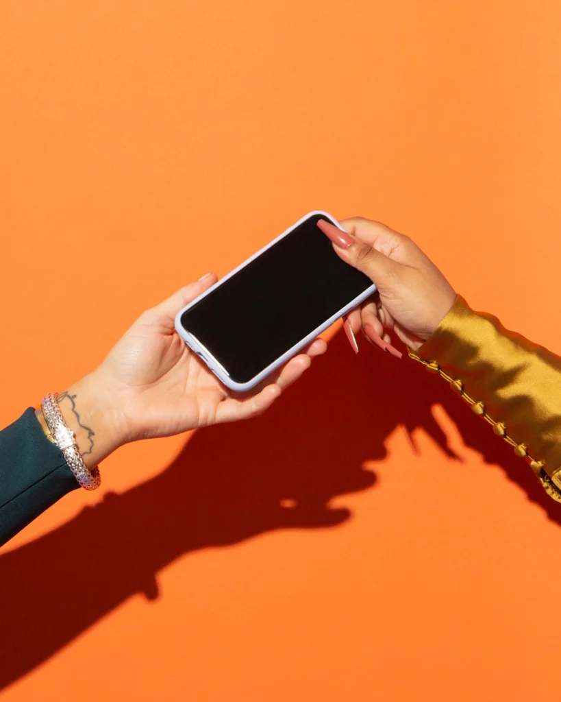 a person holding a cell phone in their hands