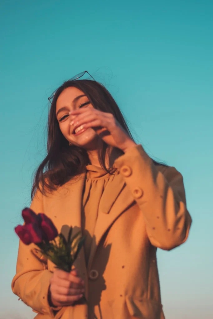 a woman holding a bouquet of flowers in her hands