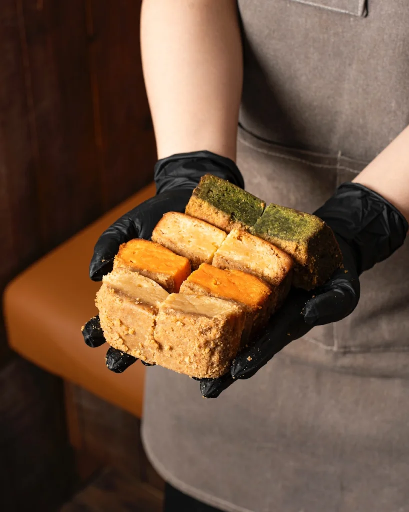 Freshly baked colorful breads are being held.